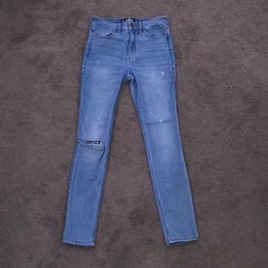 High rise lightly washed blue ripped skinny jeans